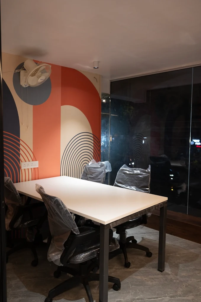 Open coworking floor with desks and members working at Think Hub